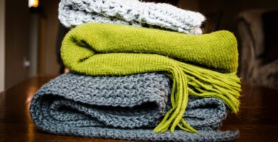 three gray, green, and white scarf on top of table
