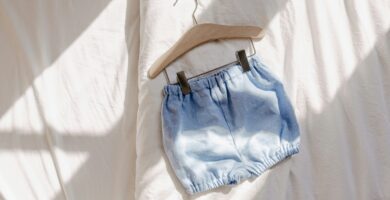 a pair of blue shorts hanging on a hanger