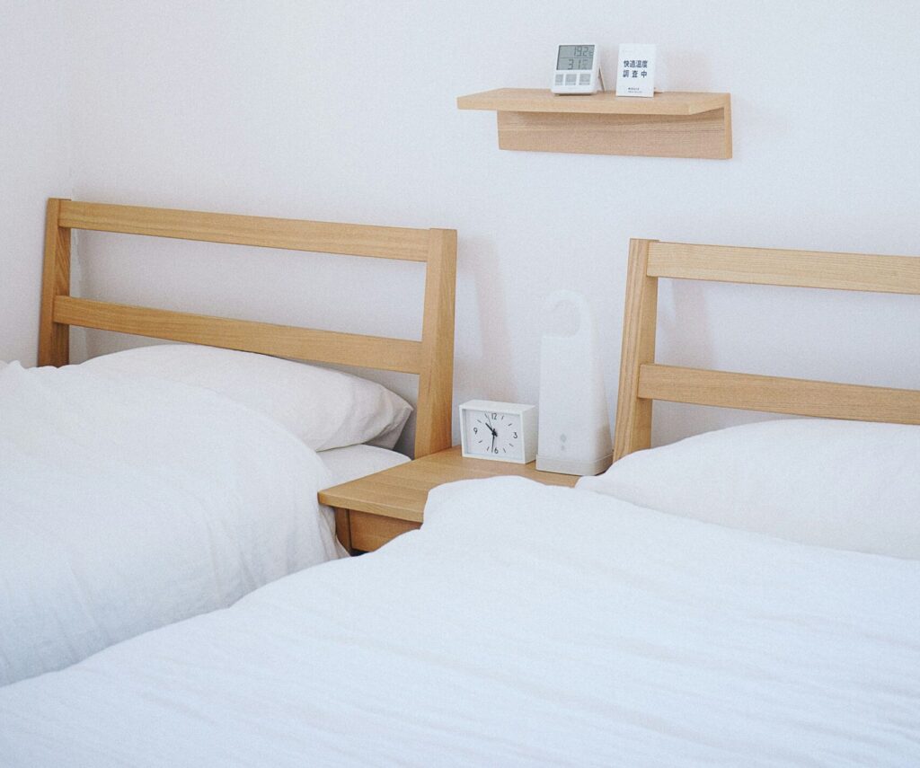 brown wooden beds with white mattresses
