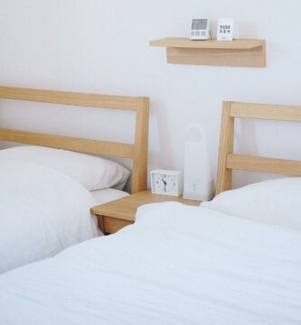 brown wooden beds with white mattresses