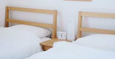 brown wooden beds with white mattresses