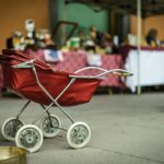 selective focus photography of red bassinet stroller