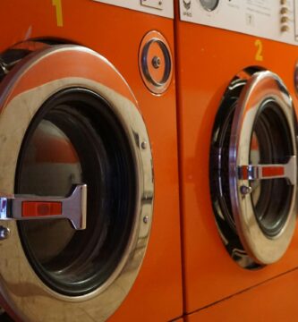 three red front-load clothes dryers