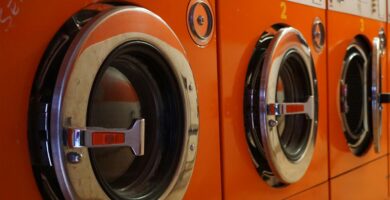 three red front-load clothes dryers