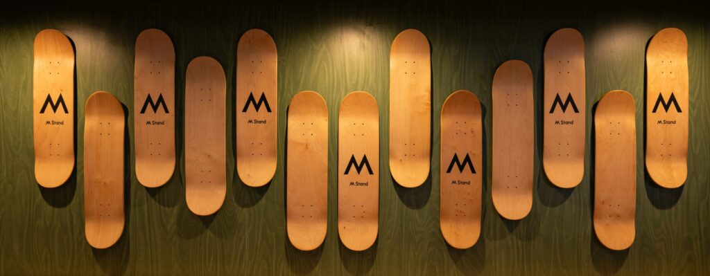 A row of wooden skis mounted to a wall