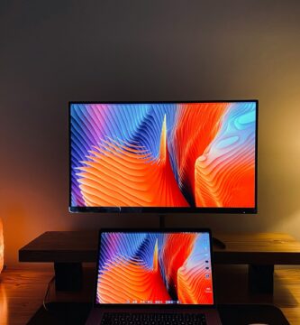 macbook pro on brown wooden table