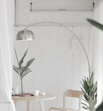white steel chair in front round table on white rug